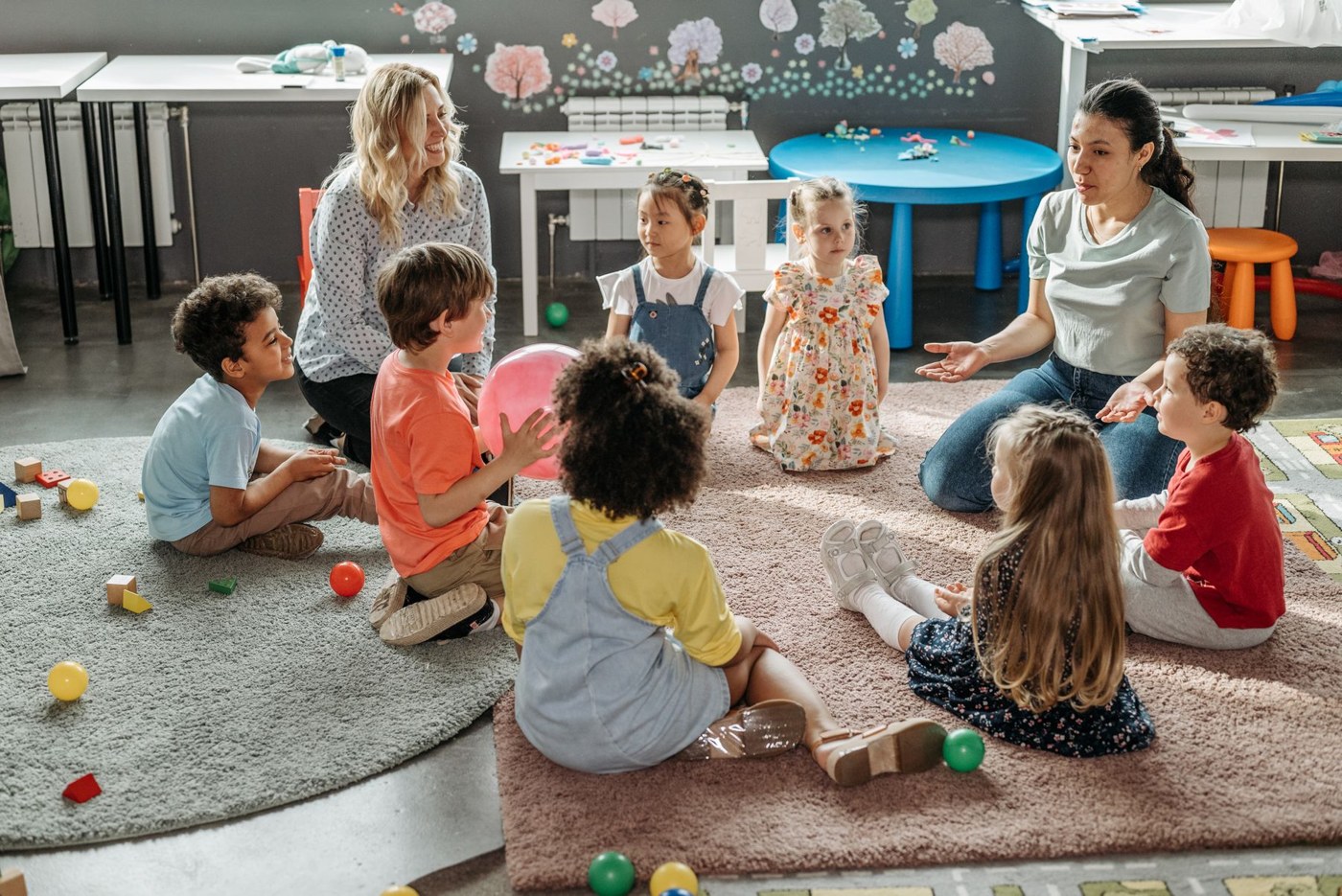 Children and teachers sitting together for classroom circle time